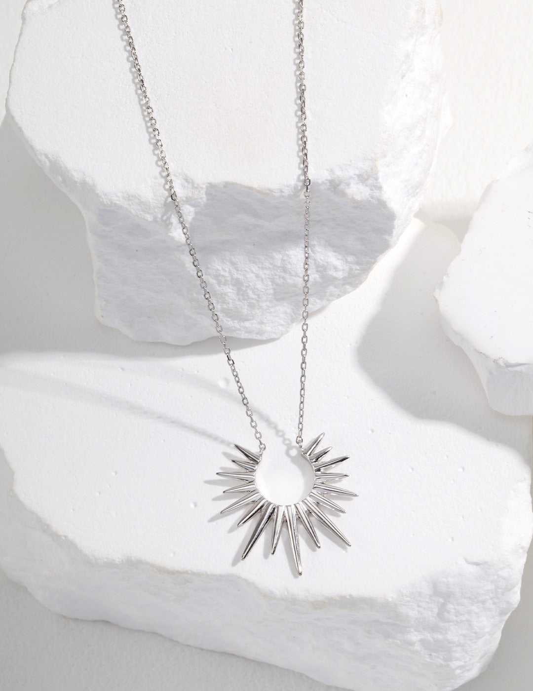 Astral Light: Chic Sunburst Pendant Necklace in Sterling Silver